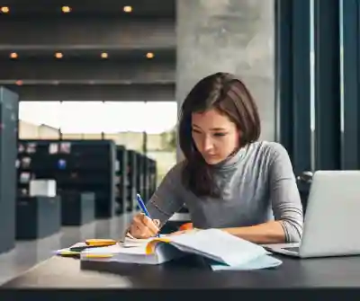 A female college student studying in a library.